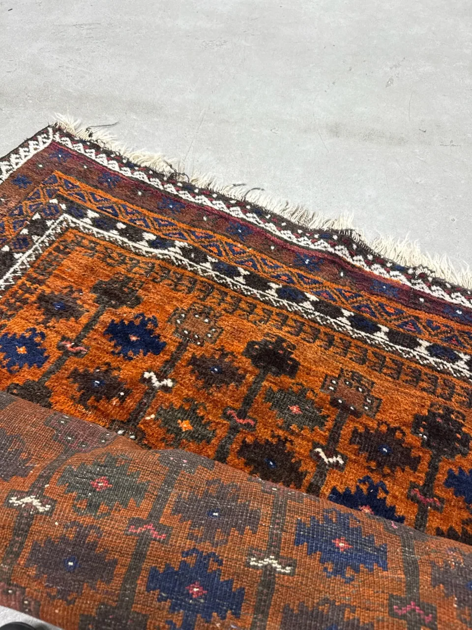 New fringe knotted onto a rug at the repair bench, picked up in Boynton Beach